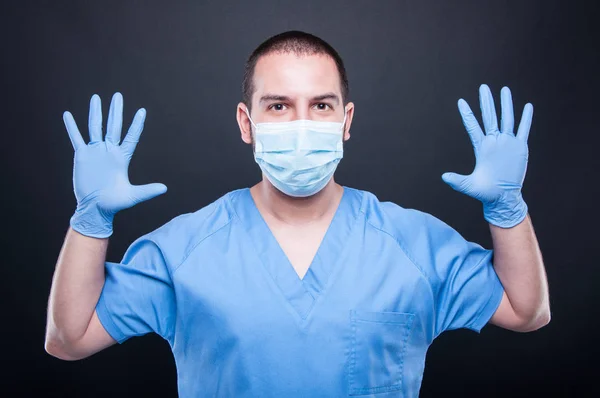 Portrait of surgeon wearing latex gloves and sterile mask — Stock Photo, Image