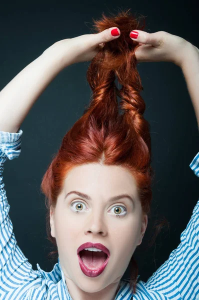 Sexy female model holds her long red hair — Stock Photo, Image