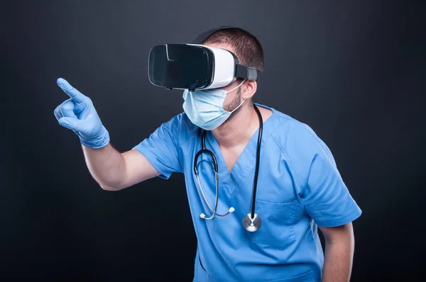 Doctor wearing scrubs using virtual reality glasses and touchscr — Stock Photo, Image