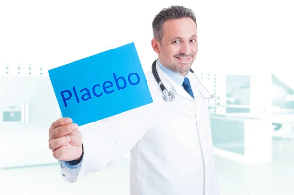 Friendly medic holding paper with placebo text — Stok Foto