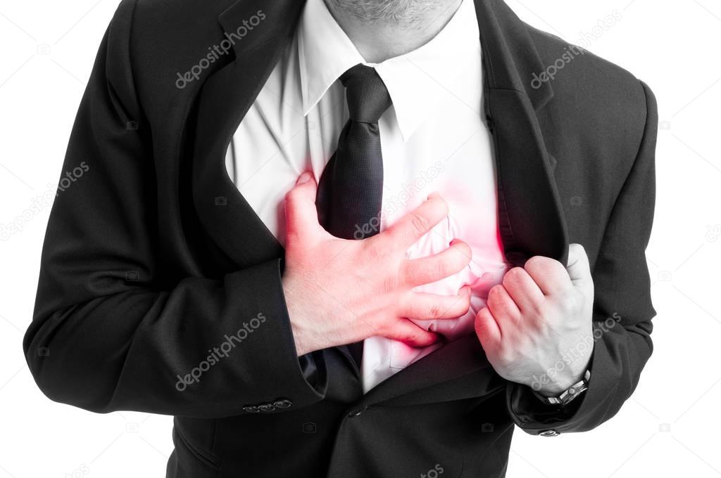 Businessman holding his heart in pain
