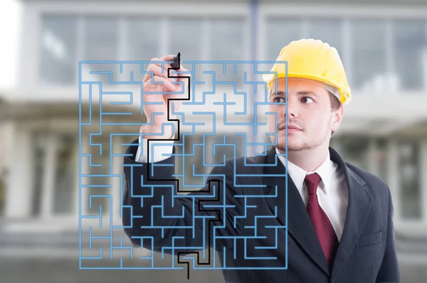 Handsome engineer solving a virtual puzzle with marker — Stock Photo, Image