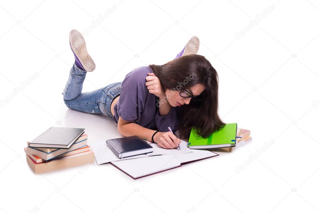 Beautiful college student taking notes from books