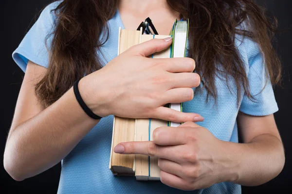 Studentin macht unhöfliche Geste beim Halten von Büchern — Stockfoto