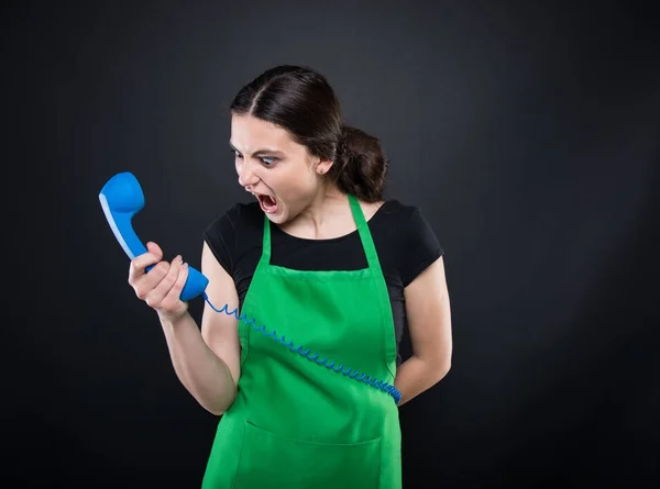 Angry female seller screaming on the phone — Stock Photo, Image