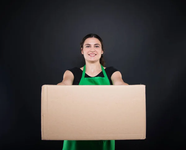 Supermarket woman staff carrying moving box — Stock Photo, Image