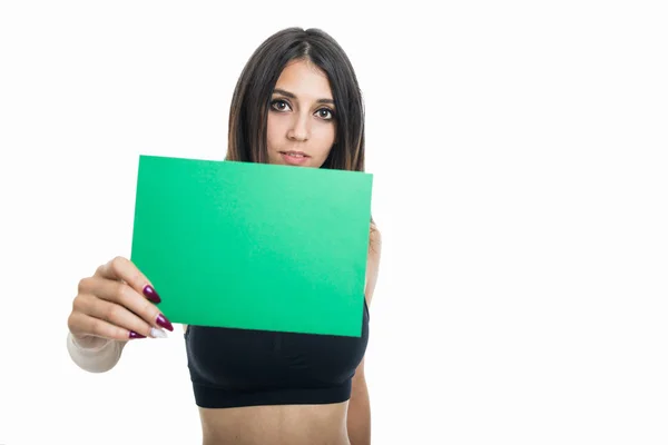 Portrait of fit girl holding green cardboard — Stock Photo, Image