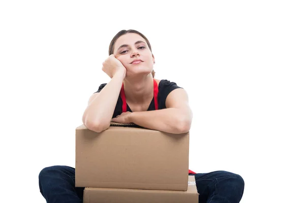 Relaxed female seller standing on cardboard boxes — Stock Photo, Image