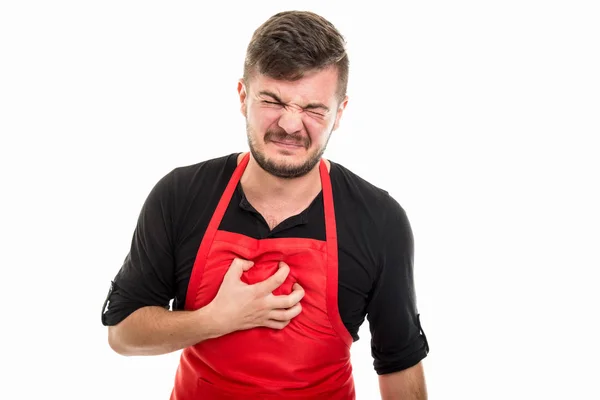 Masculino supermercado empregador segurando peito como em dor — Fotografia de Stock