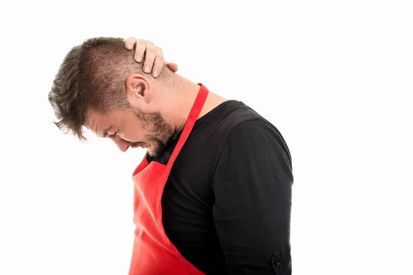 Male supermarket employer holding head like back pain — Stock Photo, Image