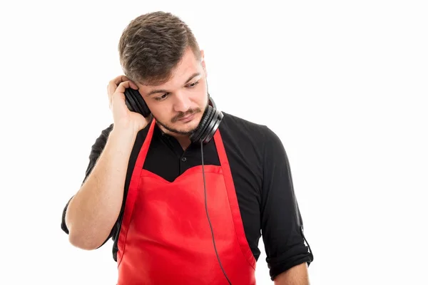 Male supermarket employer listening to one headphone — Stock Photo, Image