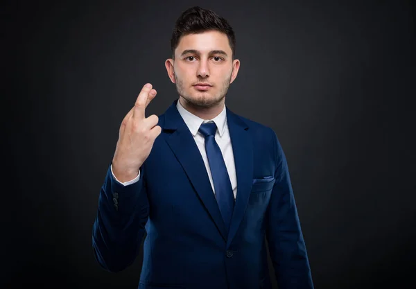 Serious executive manager holding fingers crossed — Stock Photo, Image