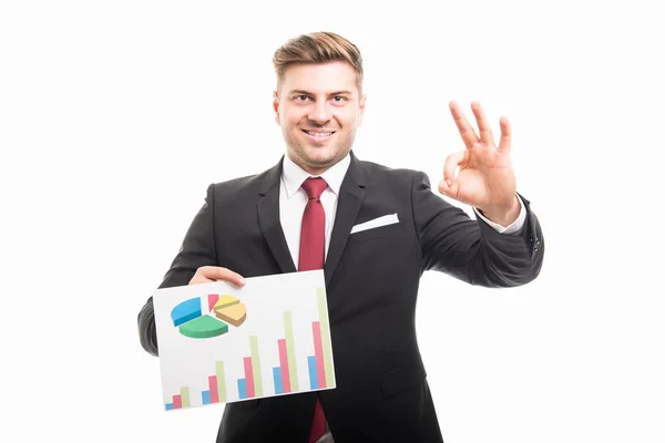 Portrait of business man holding graphs showing ok — Stock Photo, Image