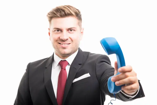 Portrait of business man holding blue telephone receiver — Stock Photo, Image