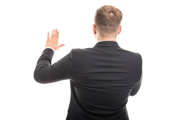 Back view of corporate business man with hand raised — Stock Photo, Image