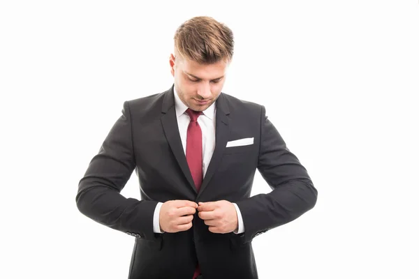 Handsome business man standing buttoning his jacket — Stock Photo, Image