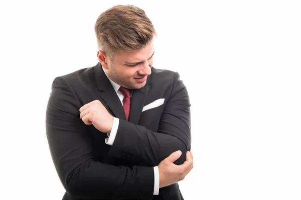 Business man standing holding elbow like hurting — Stock Photo, Image