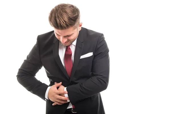 Hombre de negocios de pie sosteniendo apéndice como herido — Foto de Stock