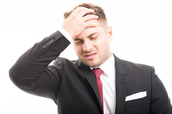 Business man standing holding forehead like hurting — Stock Photo, Image