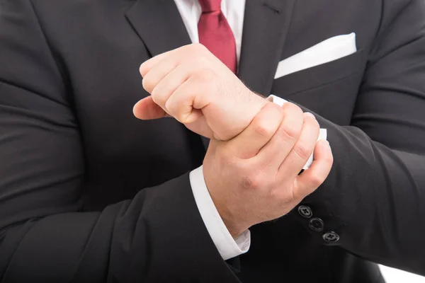 Close-up of business man standing holding wrist like hurting Stock Picture