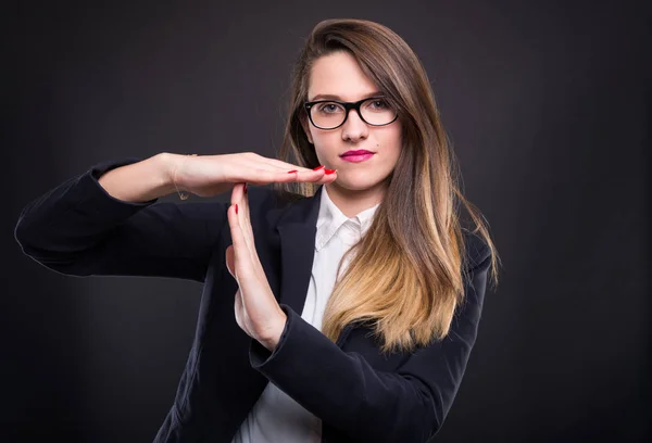 Businesswoman showing time out sign with hands