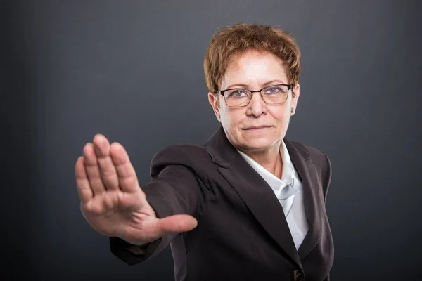 Старшая деловая леди показывает стоп-жест — стоковое фото