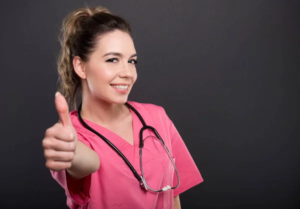 Portret atrakcyjna pani doktor pokazuje jak gest — Zdjęcie stockowe