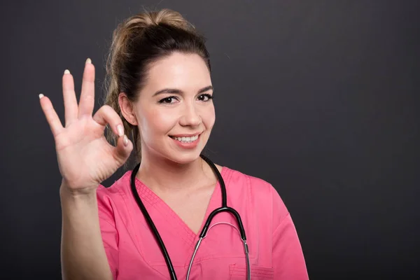 Πορτρέτο του ελκυστική γυναίκα γιατρός δείχνει εντάξει χειρονομία — Φωτογραφία Αρχείου