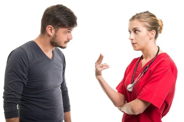 Male patient and female doctor showing number tw — Stock Photo, Image