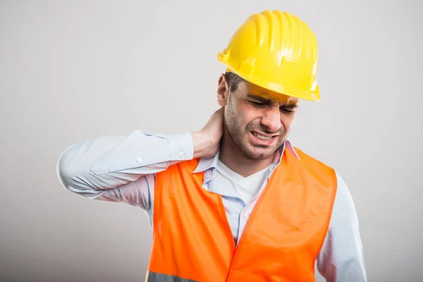 Portrait of young architect holding neck like in pain — Stock Photo, Image