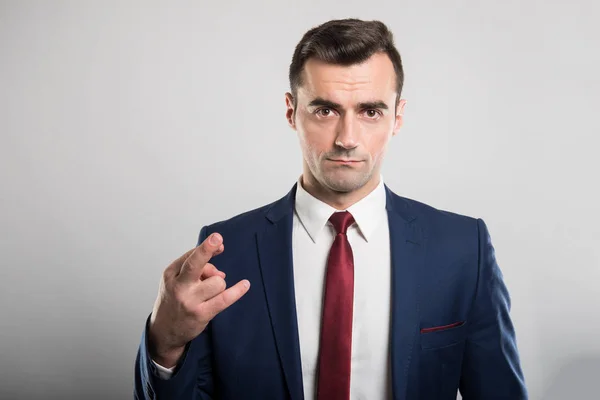 Attractive business man taking showing fingers crossed — Stock Photo, Image