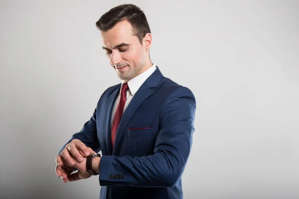 Portrait of business man wearing suit checking wrist watch — Stock Photo, Image