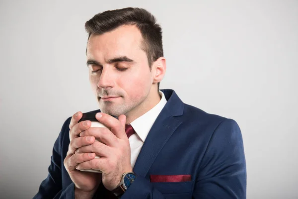 Attractive business man smelling takeaway coffee mug — Stock Photo, Image