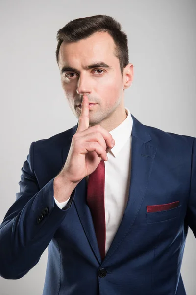 Attractive business man making sush gesture with finger — Stock Photo, Image