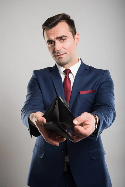 Attractive business man showing empty wallet — Stock Photo, Image