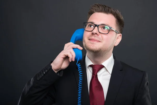 Hombre joven de negocios hablando por teléfono azul recibir — Foto de Stock