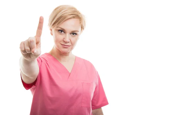 Atrakcyjna kobieta pielęgniarka ubrana na różowo zarośla wyświetlone numer jeden — Zdjęcie stockowe