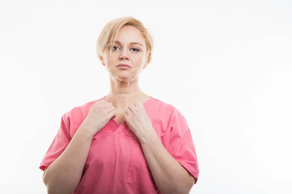 Enfermeira bonita vestindo esfoliação rosa organizando camisa — Fotografia de Stock