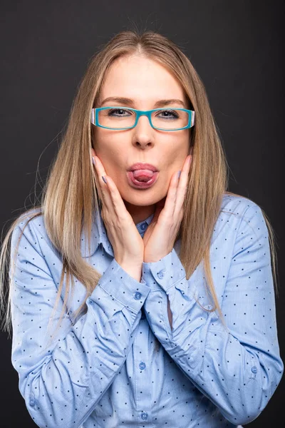 Business lady wearing blue glasses posing showing tongu — Stock Photo, Image