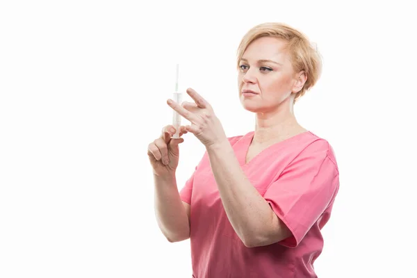 Attraktiv kvinnlig sjuksköterska bär Rosa scrubs Kontrollera sprutan — Stockfoto