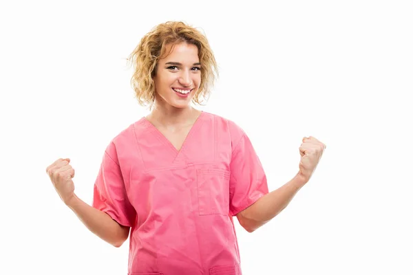 Portrait of nurse wearing pink scrub holding fists being happy — 图库照片