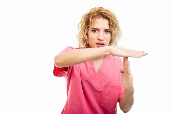 Portrait of nurse wearing pink scrub showing time out gesture — Stock Photo, Image