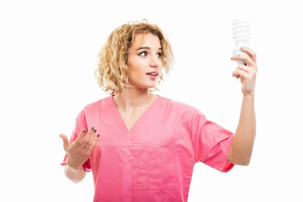 Portrait of nurse wearing pink scrub holding spiral light — Stock Photo, Image