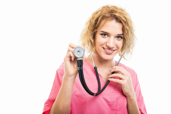 Portrait of nurse wearing pink scrub holding stethoscope — Stock Photo, Image