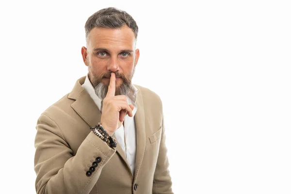 Man wearing smart casual clothes making silence gesture isolated on white background with copy space advertising area