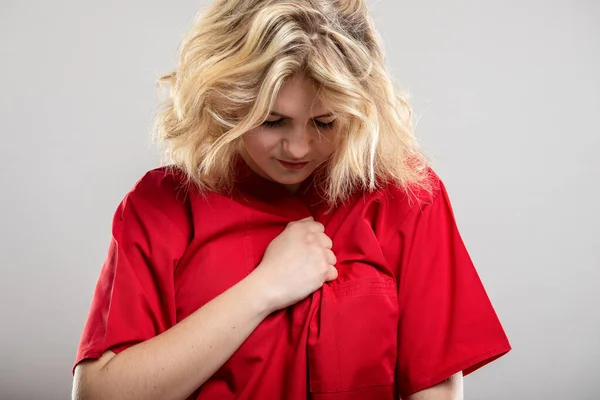 Portrait Nurse Wearing Red Scrub Making Chest Pain Gesture Studio — Stock Photo, Image