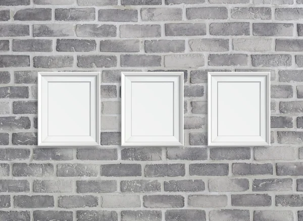 Blank frames on grey birck wall — Stock Photo, Image