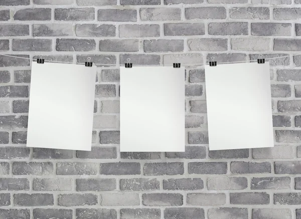 White paper on grey birck wall — Stock Photo, Image