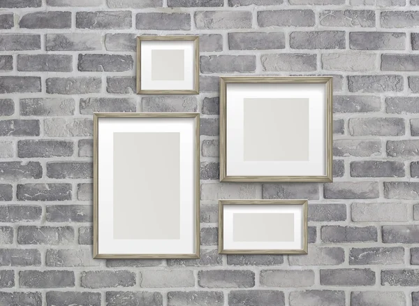Blank frames on grey birck wall — Stock Photo, Image