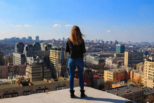 Girl standing over the city